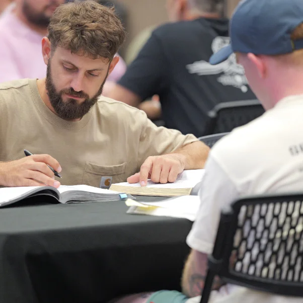 Taking notes beside an open Bible