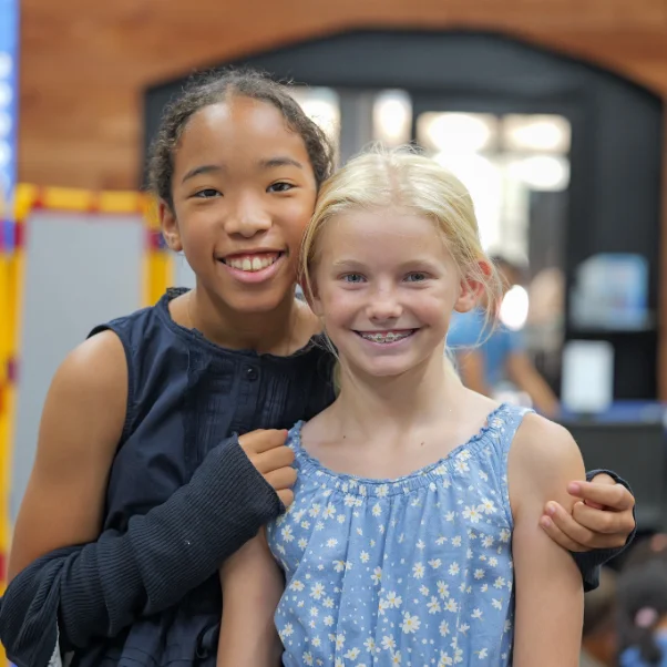 Two smiling girls at church