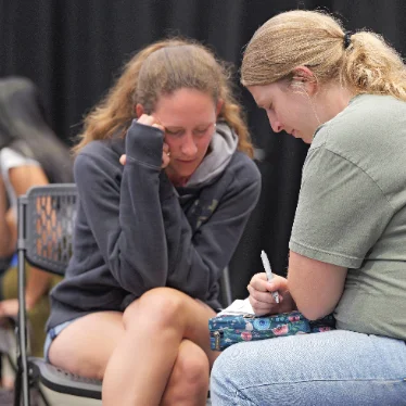 Two women praying together at a small group